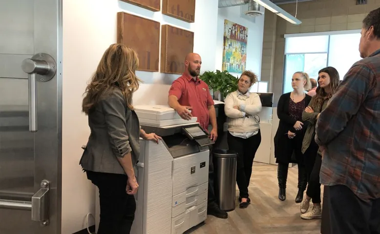 An Orange County office worker using a Next Level office copier